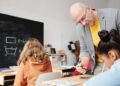 Lehrer mit Kindern in einer Volksschulklasse